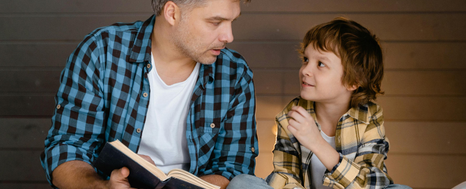 Father and son reading together