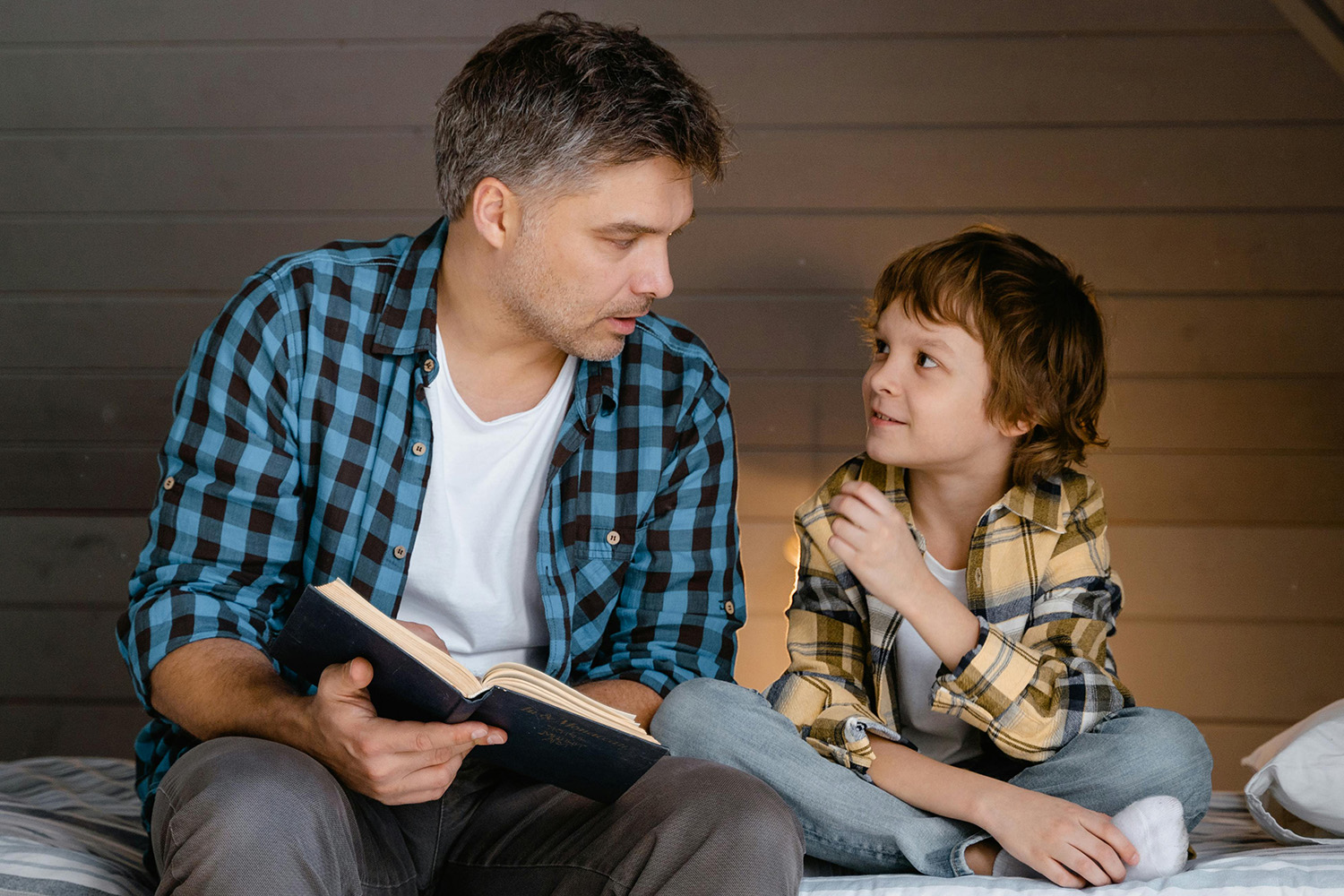 Father and son reading together