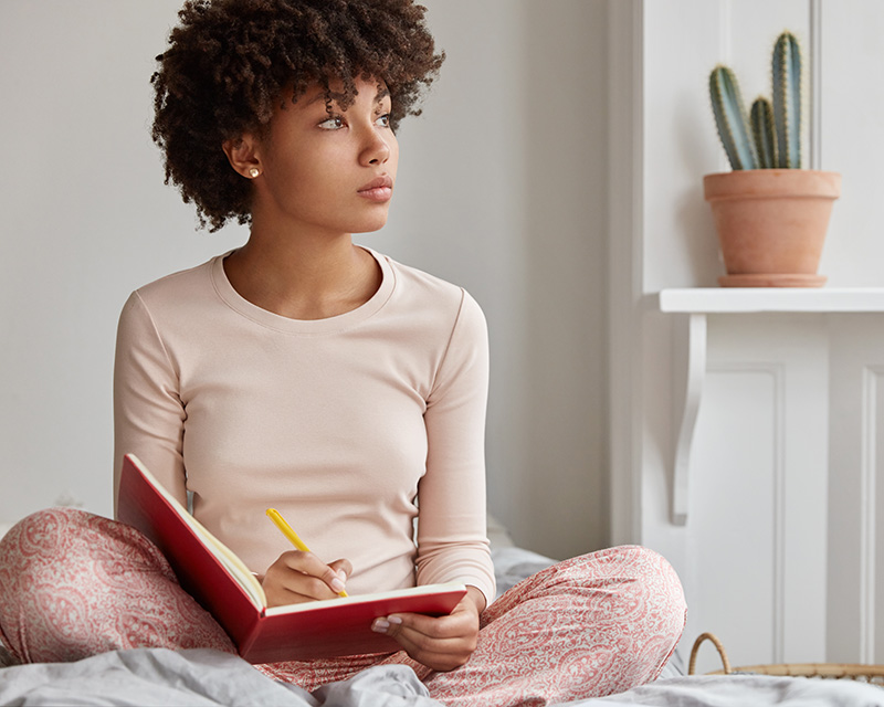 Teenager writing in a journal; Counseling for teens in Plano