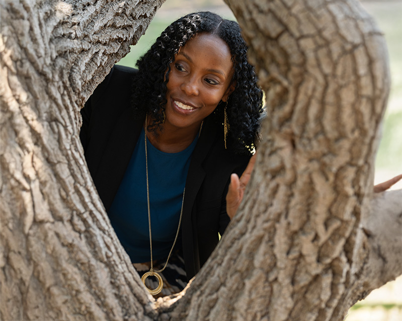 tamra_williams_therapist_plano Tamra Williams looking through a tree