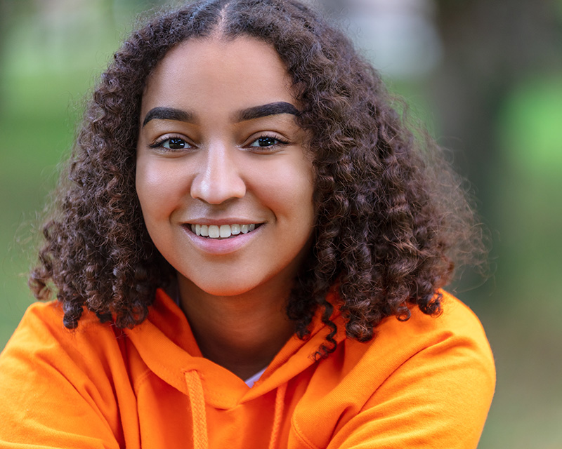 Young woman with orange sweatshirt